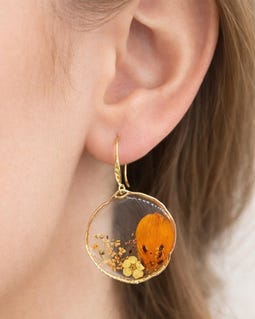 Women's dangling hoop earrings with real orange flowers in resin. Resin jewelry made from pressed dried flowers. A unique gift.